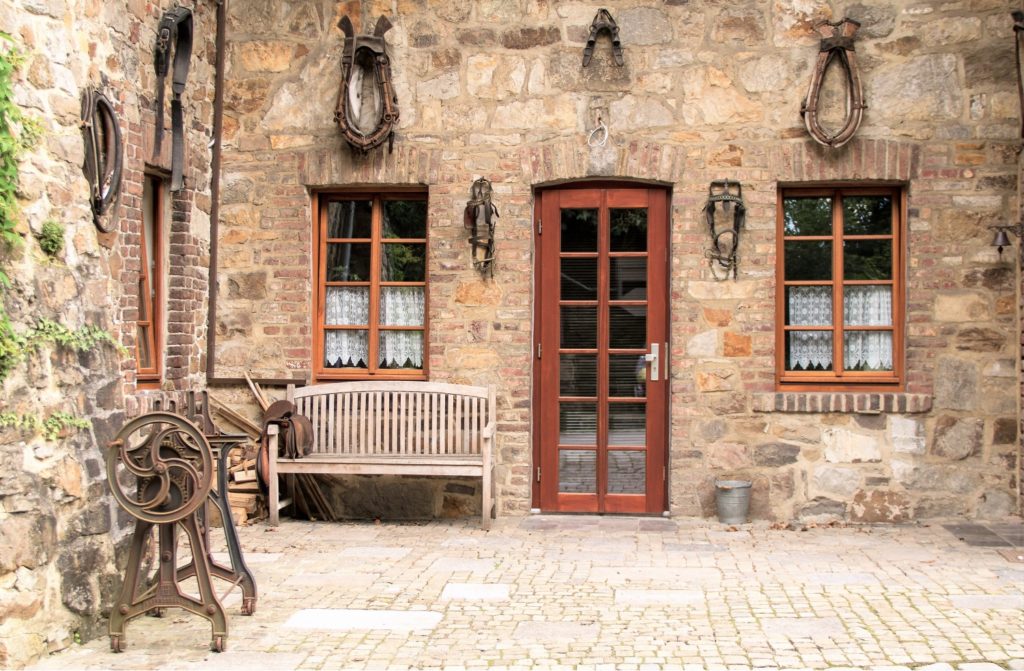 Wood entry door and windows on a stone European house